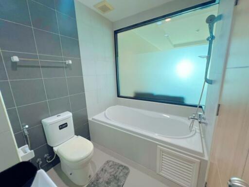 Modern bathroom with bathtub and large window