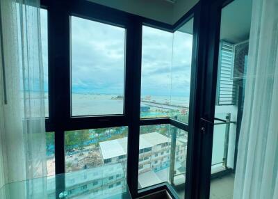 View from the window of a high-rise building overlooking a large body of water