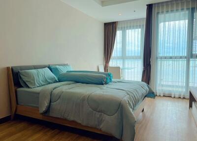 Modern bedroom with large windows and blue bedding