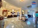 Spacious living room with ornate furnishings and chandelier