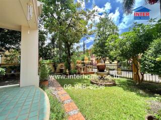 Well-maintained garden with pathway and lush greenery.