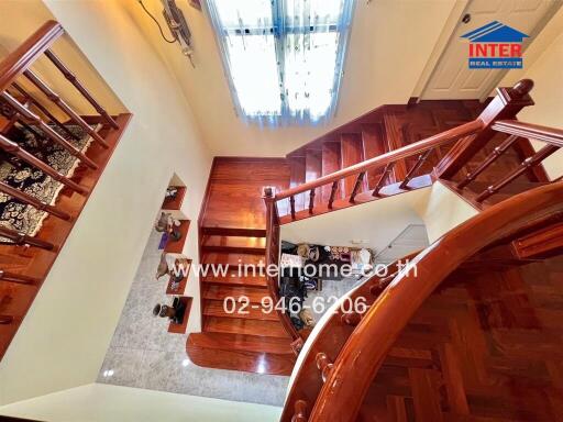 Interior view showcasing a wooden staircase with decorative elements