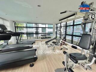 Modern gym with various exercise equipment and large windows