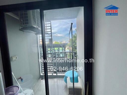 Balcony with sliding glass doors, an outdoor air conditioning unit, and a view of the surrounding area