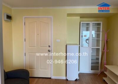 Living area with door, cabinet, and coat rack