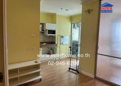 Apartment kitchen area with visible shelving and doorway