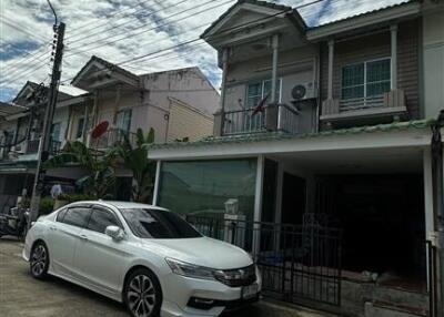 Front view of a building with a parked car