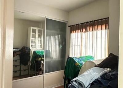 Bedroom with sliding glass wardrobe, bed and natural light