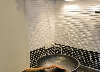 Modern kitchen with a stovetop and frying pan