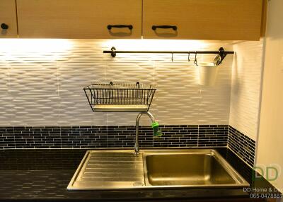 Modern kitchen sink with backsplash and cabinets