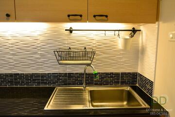 Modern kitchen sink with backsplash and cabinets