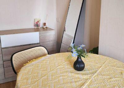 Dining area with round table, mirror, and dresser