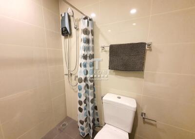 Bathroom with shower, toilet, and towel rack
