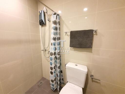 Bathroom with shower, toilet, and towel rack