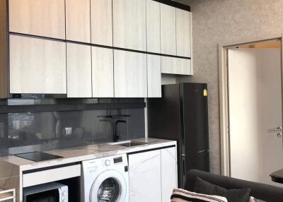 Modern kitchen area with appliances and storage in a living space