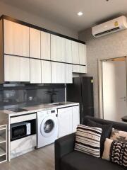 Modern kitchen area with appliances and storage in a living space