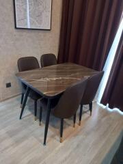 Modern dining area with marble table and brown chairs