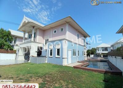 Two-story house with a lawn and swimming pool