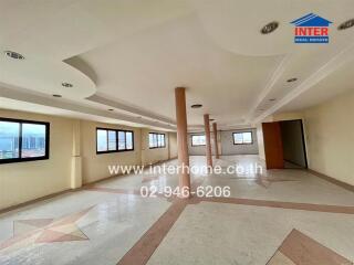 Spacious empty room with large windows and tiled floors