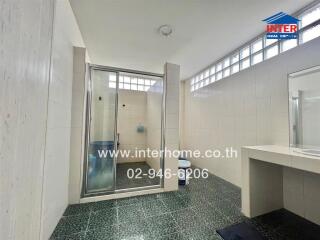 Modern bathroom with a spacious shower area and a vanity with mirror