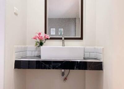 Modern bathroom sink with mirror and floral decor