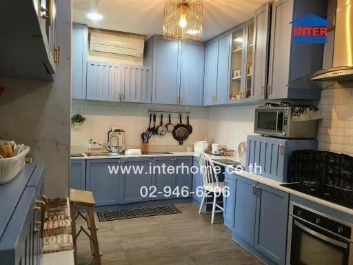 Modern kitchen with blue cabinets and integrated appliances