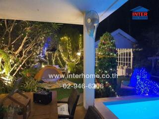 Outdoor area with garden, pool, lights, and a tent setup