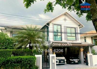 Exterior view of a house with a driveway and two cars