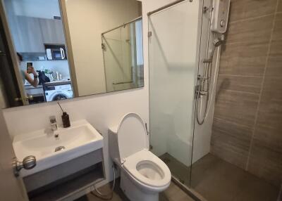 Modern bathroom with glass shower and wall-mounted sink