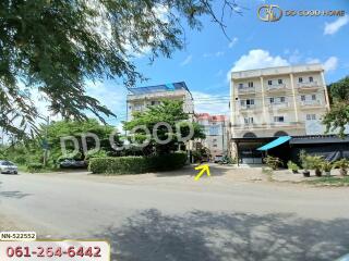 Exterior view of residential buildings with a nearby street