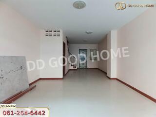 Spacious empty room with light-colored walls and tile flooring.