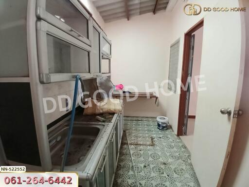 Basic kitchen with tiled floor and storage cabinets