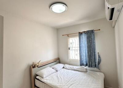Cozy bedroom with a double bed, window, and modern lighting.