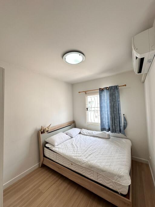 Cozy bedroom with a double bed, window, and modern lighting.