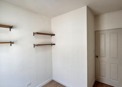 Minimalistic bedroom with wooden shelves and door