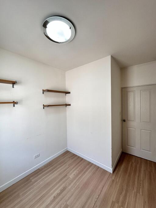 Minimalistic bedroom with wooden shelves and door