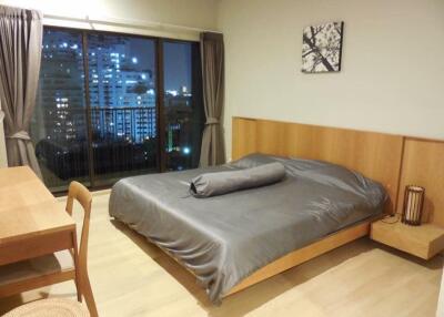 Modern bedroom with large window and city view