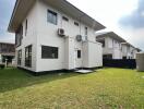 Rear exterior view of a modern two-story house with lawn