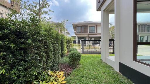 Photo showing the exterior of a residential house with a garden