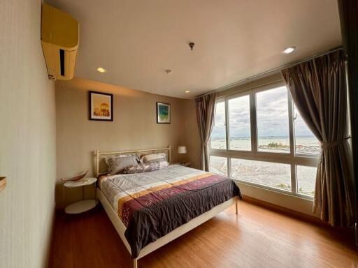 Spacious bedroom with a large window and scenic view