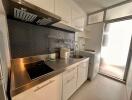 Modern kitchen with stainless steel countertop and backsplash