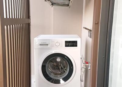 Small laundry area with a Bosch washing machine and dryer vent