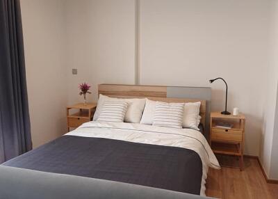 Modern bedroom with wooden furniture and a neatly made bed