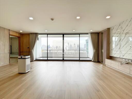 Spacious living room with large windows and city view