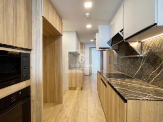 Modern kitchen with wooden cabinets and marble countertops