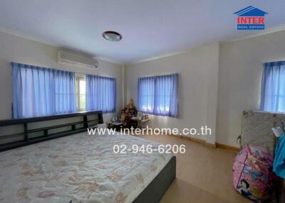 Bedroom with large windows and air conditioning