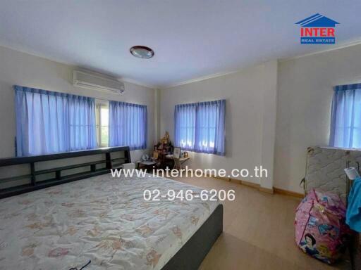 Bedroom with large windows and air conditioning