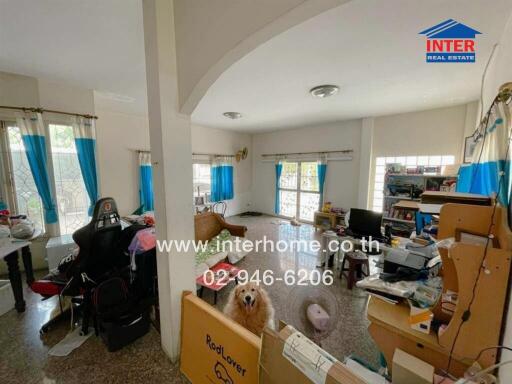 Spacious living area with large windows and natural sunlight