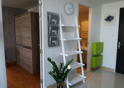 Hallway with storage ladder and closet