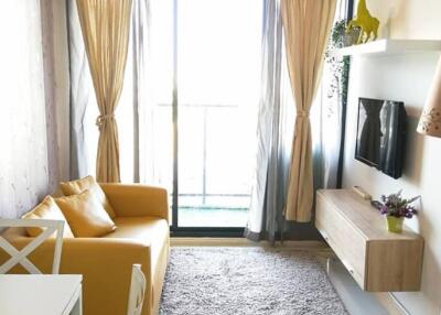 Bright living room with yellow sofa and balcony access